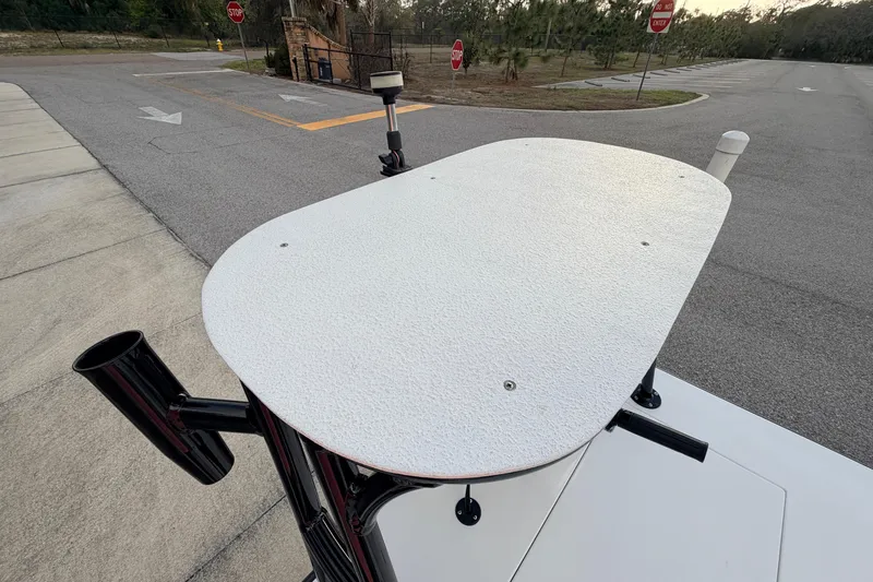 Slide: The Image of 2023 Dorado 16 Skiff boat platform with rod holders, parked on a paved area. - 49