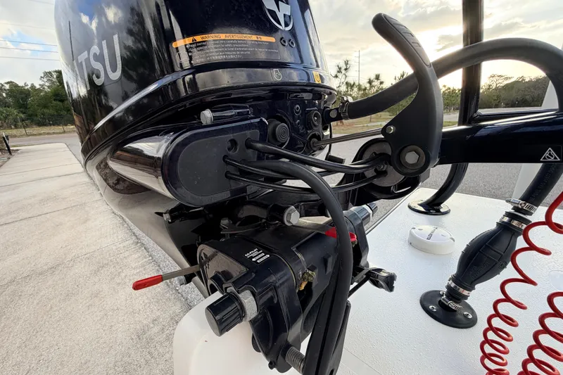 Slide: The Image of Close-up of a 2023 Dorado 16 Skiff outboard motor with control cables. - 50