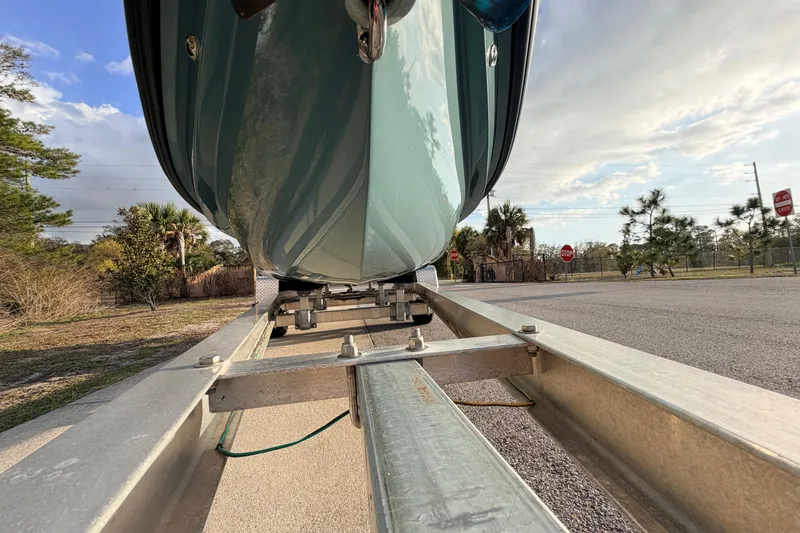 Slide: The Image of 2023 Dorado 16 Skiff boat on trailer, parked on roadside under cloudy sky. - 8