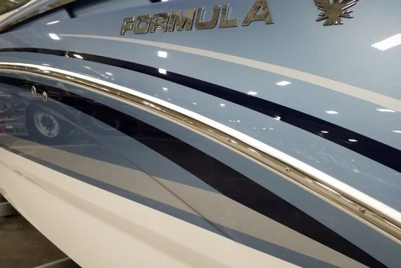 Slide: The Image of 2020 Formula 310 Bowrider OB boat with sleek blue and white design. - 3