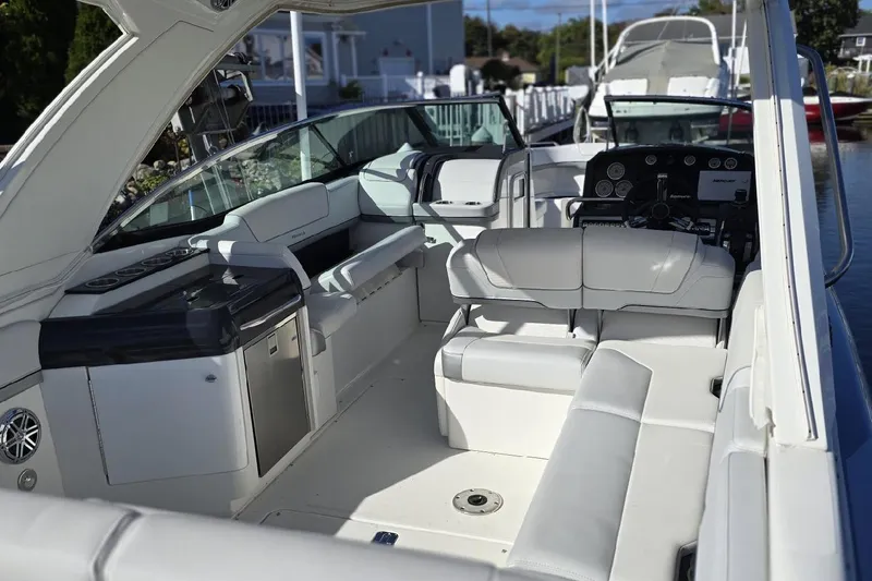 Slide: The Image of 2020 Formula 310 Bowrider OB interior with white seating and modern dashboard. - 4