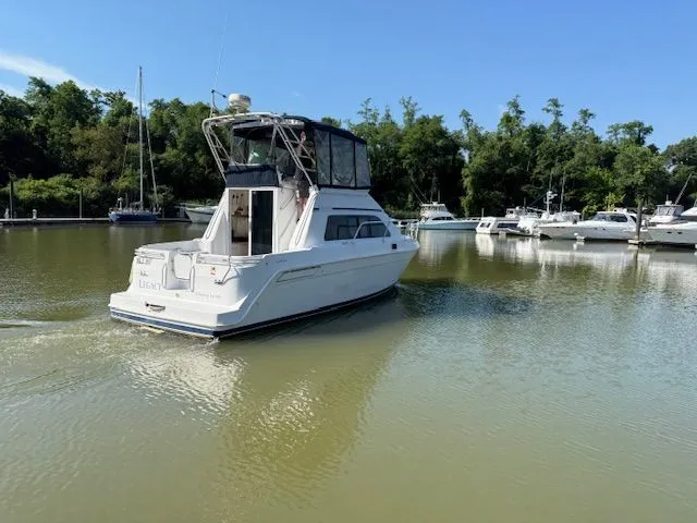 Slide: The Image of 1998 Mainship Sedan Bridge in a calm harbor. - 10