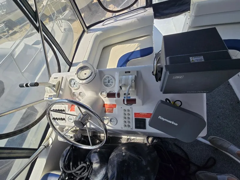 Slide: The Image of 1998 Mainship Sedan Bridge helm with navigation equipment. - 14