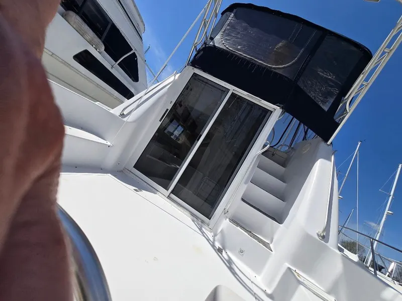 Slide: The Image of 1998 Mainship Sedan Bridge with stairs and canopy. - 16