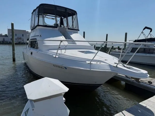 Slide: The Image of 1998 Mainship Sedan Bridge at dock, sunny day. - 4