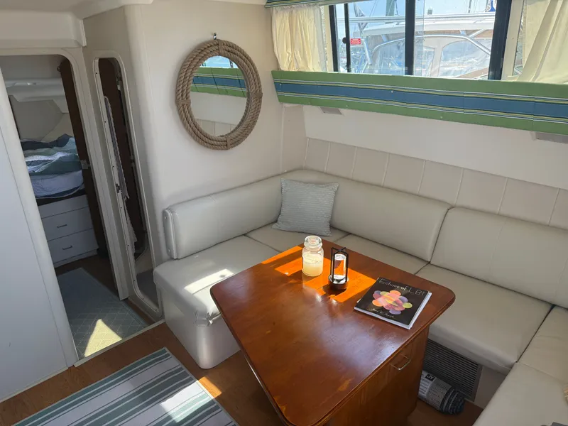 Slide: The Image of Interior of a 1998 Mainship Sedan Bridge with cozy seating area. - 5