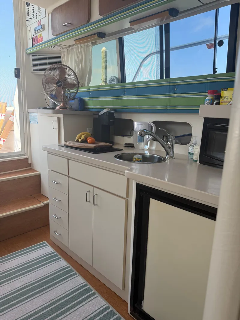 Slide: The Image of Kitchen area on a 1998 Mainship Sedan Bridge boat. - 6