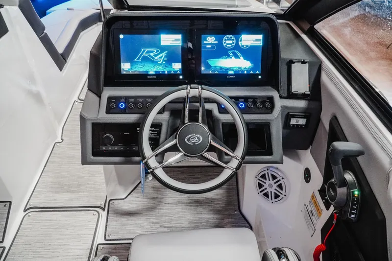 Slide: The Image of 2026 Cobalt R4 boat dashboard with dual screens and modern steering wheel. - 13