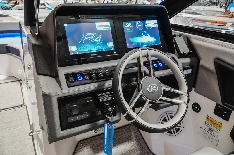 Slide: The Image of 2026 Cobalt R4 boat dashboard with advanced navigation screens and sleek steering wheel. - 14