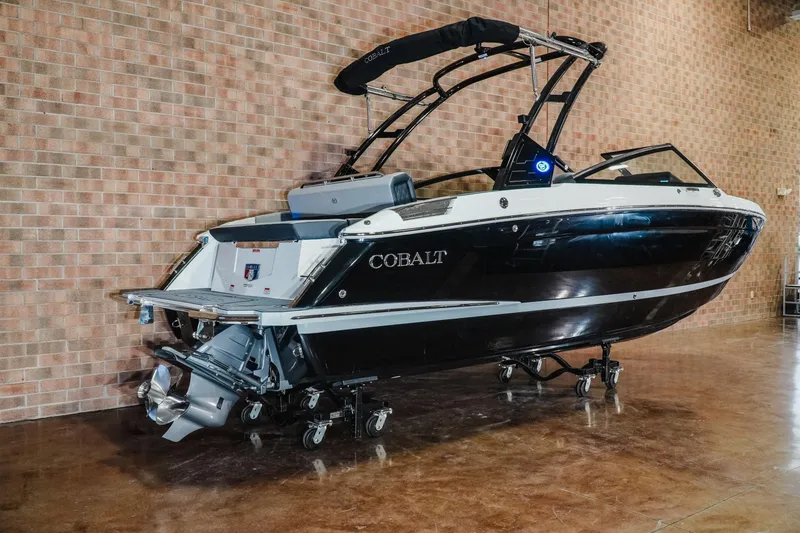 Slide: The Image of 2026 Cobalt R4 boat displayed indoors on a polished floor. - 2