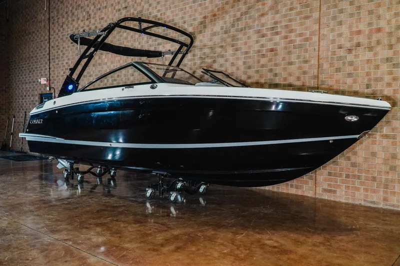 Slide: The Image of 2026 Cobalt R4 boat displayed indoors against a brick wall. - 3