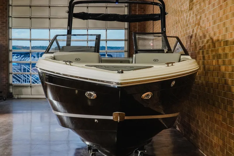 Slide: The Image of 2026 Cobalt R4 boat in showroom, front view with glass doors in background. - 4