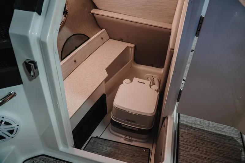 Slide: The Image of 2026 Cobalt R6 boat interior with compact portable toilet in cabin. - 17