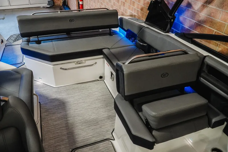 Slide: The Image of 2026 Cobalt R6 boat interior with gray seating and ambient blue lighting. - 21