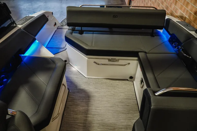 Slide: The Image of 2026 Cobalt R6 boat interior with sleek seating and ambient blue lighting. - 22
