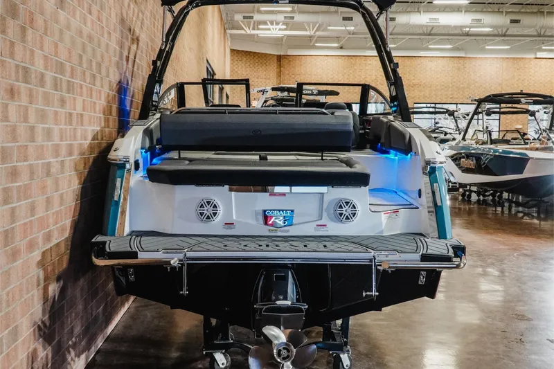 Slide: The Image of 2026 Cobalt R6 boat displayed indoors, showcasing rear design and seating. - 7