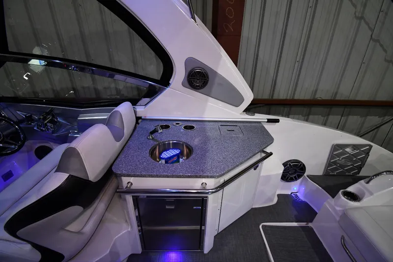 Slide: The Image of 2014 Chaparral 327 SSX boat interior with kitchenette and seating area. - 15