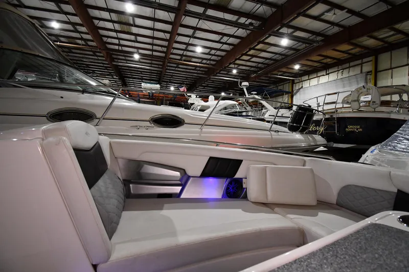 Slide: The Image of 2014 Chaparral 327 SSX boat interior in a storage facility with other boats. - 19