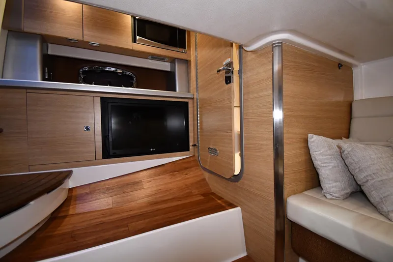Slide: The Image of Interior of 2014 Chaparral 327 SSX boat with wood finish and modern amenities. - 24