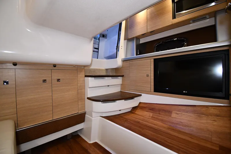 Slide: The Image of Interior of 2014 Chaparral 327 SSX boat with wood cabinetry and modern amenities. - 25