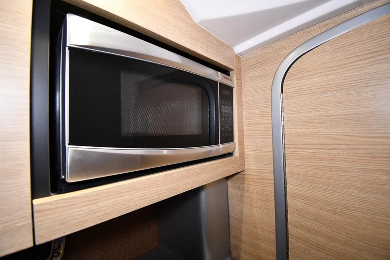 Slide: The Image of Built-in microwave in 2014 Chaparral 327 SSX boat interior. - 29