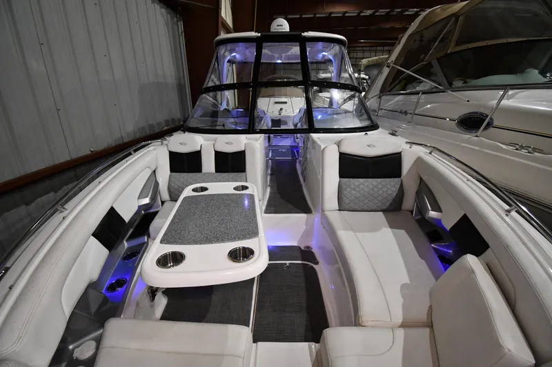 Slide: The Image of 2014 Chaparral 327 SSX boat interior with luxurious seating and ambient lighting. - 3