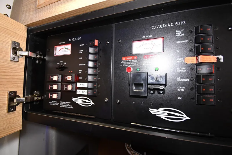 Slide: The Image of Electrical control panel of a 2014 Chaparral 327 SSX boat, featuring switches and meters. - 31