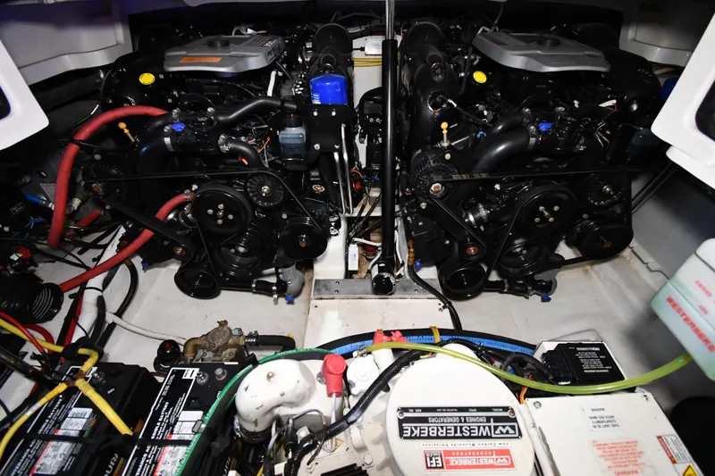 Slide: The Image of Engine compartment of a 2014 Chaparral 327 SSX boat, showcasing dual engines and components. - 32
