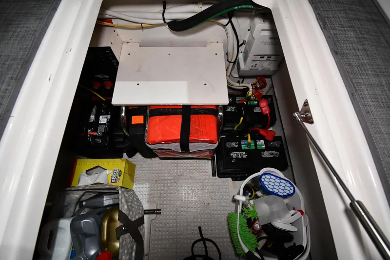 Slide: The Image of Storage compartment of 2014 Chaparral 327 SSX boat with batteries and equipment. - 41