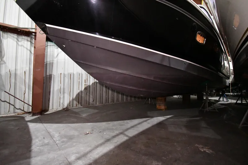 Slide: The Image of 2014 Chaparral 327 SSX boat hull in storage, side view. - 42