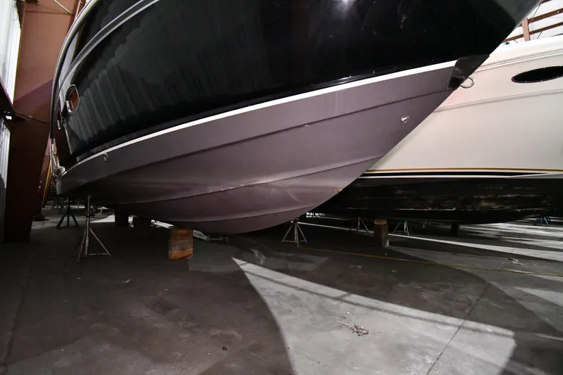 Slide: The Image of 2014 Chaparral 327 SSX boat hull in storage, side view. - 43