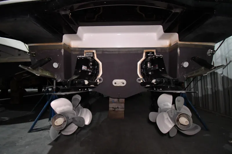 Slide: The Image of Rear view of 2014 Chaparral 327 SSX boat with dual propellers in a storage facility. - 44