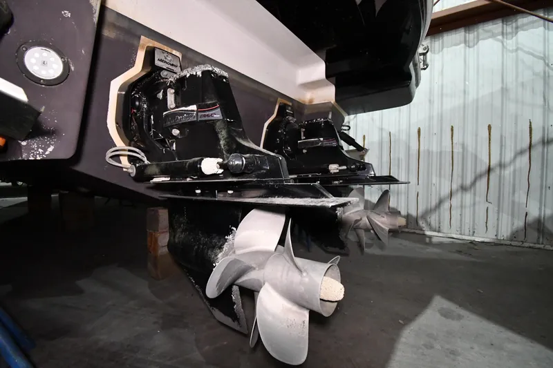 Slide: The Image of 2014 Chaparral 327 SSX boat stern with dual propellers in a storage facility. - 45