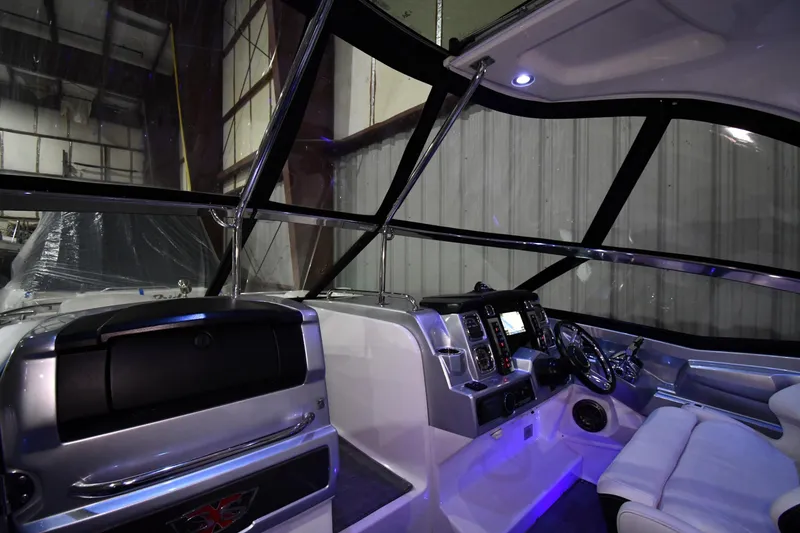 Slide: The Image of Interior view of 2014 Chaparral 327 SSX boat cockpit with modern controls and seating. - 5