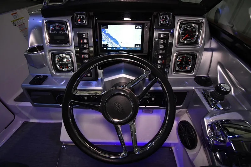 Slide: The Image of Dashboard of a 2014 Chaparral 327 SSX boat with steering wheel and navigation display. - 7