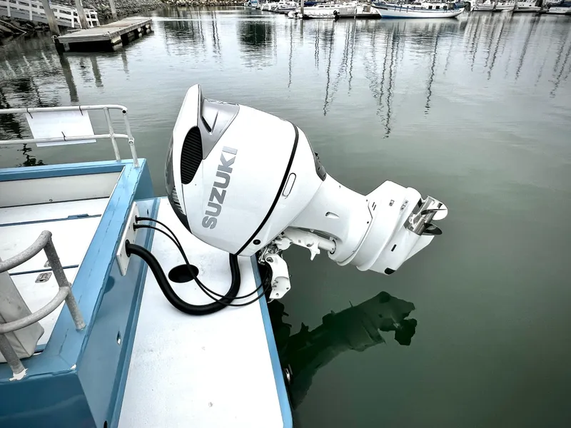 Slide: The Image of Outboard motor on ACB 30 boat, docked in a marina, 2003 model. - 10