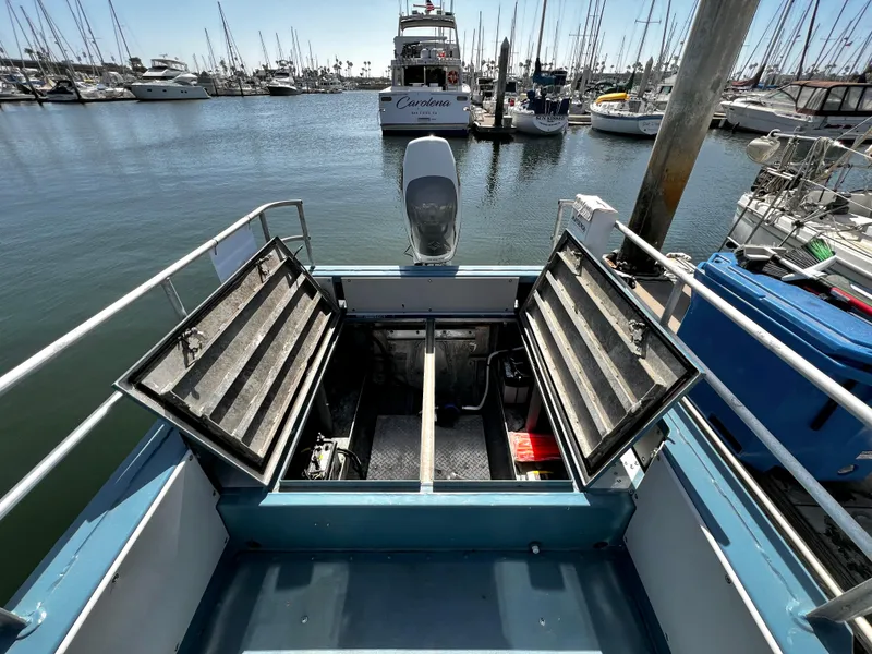 Slide: The Image of Open storage compartments on a 2003 ACB 30 boat docked in a marina. - 13