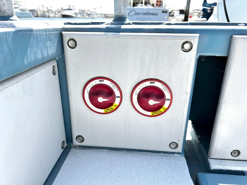 Slide: The Image of Dual battery switches on a 2003 ACB 30 boat, set to "Off" position. - 19
