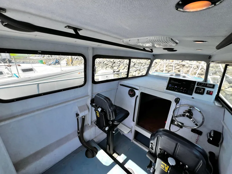 Slide: The Image of Interior of a 2003 ACB 30 boat with steering wheel and control panel. - 21