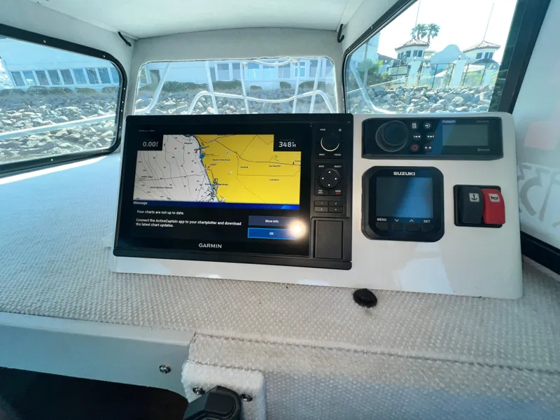 Slide: The Image of ACB 30 boat dashboard with navigation system and controls, 2003 model. - 23