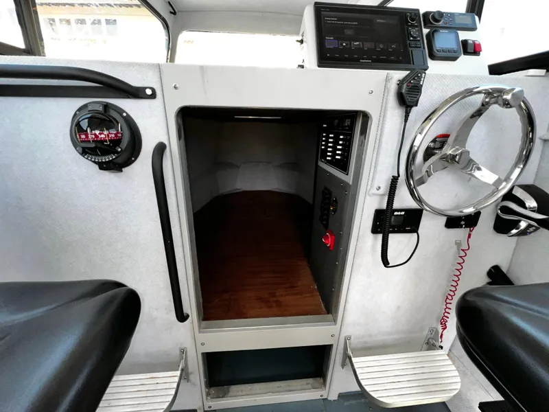 Slide: The Image of Interior of a 2003 ACB 30 boat cockpit with steering wheel and navigation equipment. - 25