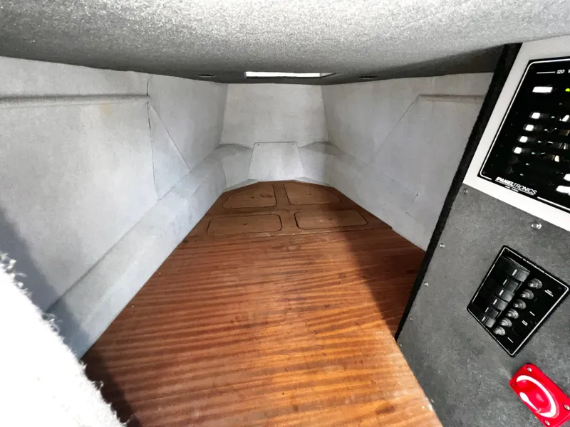 Slide: The Image of Interior cabin of a 2003 ACB 30 boat with wooden flooring and control panel. - 26