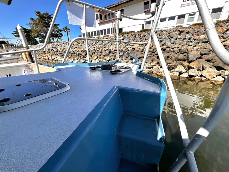 Slide: The Image of ACB 30 boat docked near rocky shoreline, 2003 model. - 3