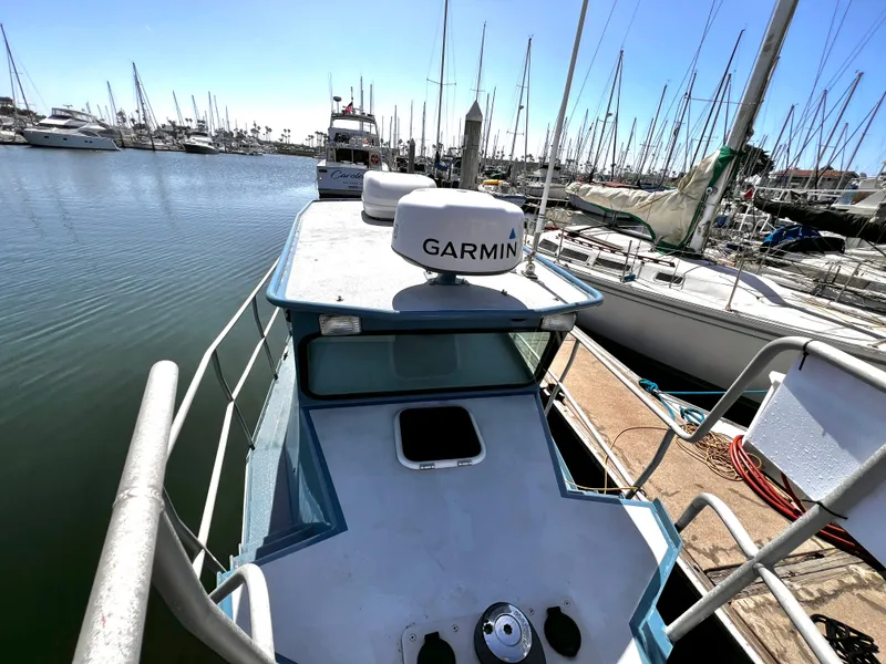 Slide: The Image of Boat docked at marina, featuring Garmin equipment, surrounded by sailboats. - 5
