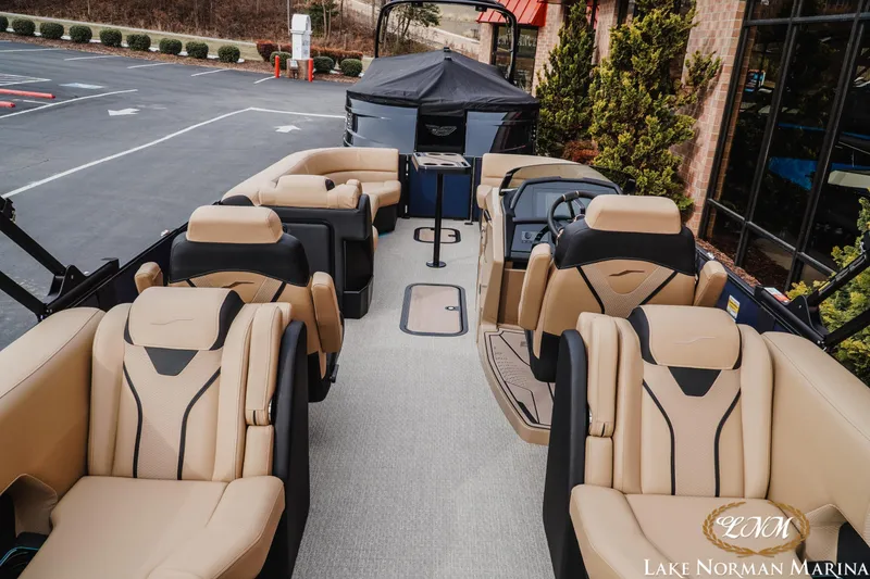 Slide: The Image of 2026 Evotti 725QL luxury boat interior with beige and black seating at Lake Norman Marina. - 6