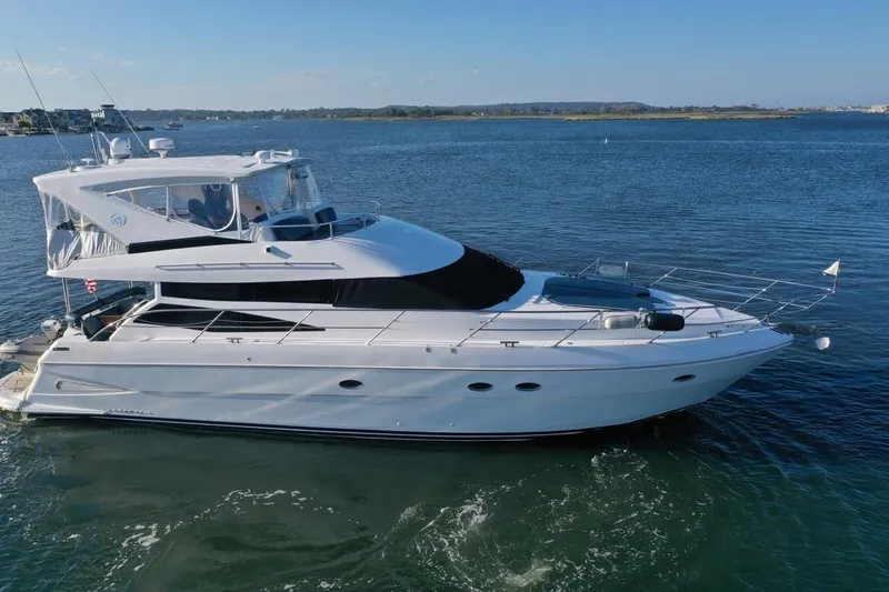 The Image of 2005 Neptunus 56 Flybridge yacht cruising on calm waters under clear skies. - 0