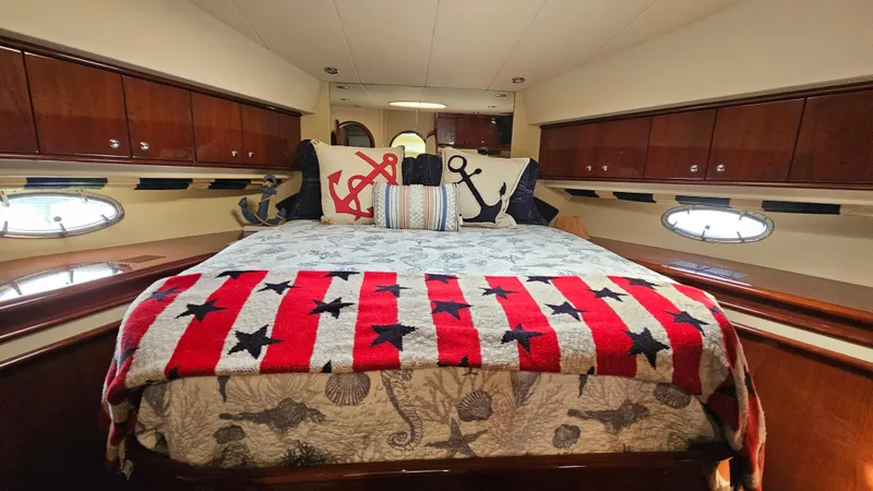 Slide: The Image of Luxurious 2005 Neptunus 56 Flybridge yacht bedroom with nautical-themed decor. - 19