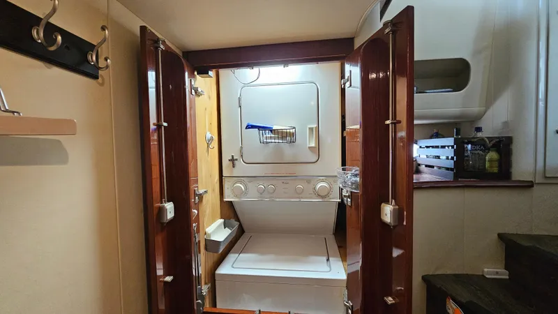 Slide: The Image of Laundry area inside 2005 Neptunus 56 Flybridge yacht with stacked washer and dryer. - 35