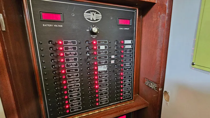 Slide: The Image of Electrical panel of 2005 Neptunus 56 Flybridge yacht with illuminated switches and indicators. - 36