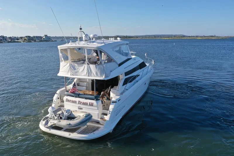 Slide: The Image of 2005 Neptunus 56 Flybridge yacht cruising on a serene waterway. - 9